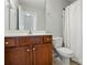 Bathroom features a wood vanity, toilet, and shower with a white curtain at 6333 Cory Bret Ln, Charlotte, NC 28278