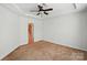 A simple bedroom with neutral walls, carpet floors, and recessed lighting, offering a calm and comfortable space at 6333 Cory Bret Ln, Charlotte, NC 28278