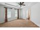 A spacious bedroom with modern ceiling fan, windows, and a door leading to a walk-in closet at 6333 Cory Bret Ln, Charlotte, NC 28278
