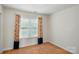 Bedroom with neutral carpet, walls, and window, accentuated by colorful floral curtains at 6333 Cory Bret Ln, Charlotte, NC 28278