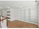 Bonus room with carpet and a wall-to-wall white built-in bookshelf at 6333 Cory Bret Ln, Charlotte, NC 28278