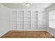 Bonus room with carpet and a wall-to-wall white built-in bookshelf at 6333 Cory Bret Ln, Charlotte, NC 28278