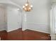 Dining room boasting elegant trimwork, hardwood floors, and a stylish chandelier at 6333 Cory Bret Ln, Charlotte, NC 28278