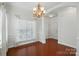 Dining room with hardwood flooring, archway, and a classic chandelier for elegant dining experiences at 6333 Cory Bret Ln, Charlotte, NC 28278