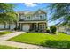 Beautiful two-story home featuring stone details, a manicured lawn, and a cozy covered entryway at 6333 Cory Bret Ln, Charlotte, NC 28278