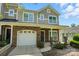 Charming two-story home with stone veneer, a garage, and a covered porch that creates curb appeal at 6333 Cory Bret Ln, Charlotte, NC 28278