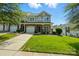 Attractive two-story home featuring stone accents, a well-maintained lawn, and an inviting front entrance at 6333 Cory Bret Ln, Charlotte, NC 28278