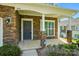 Welcoming front porch of a home featuring stone pillars, outdoor lighting, and space for seating at 6333 Cory Bret Ln, Charlotte, NC 28278