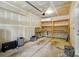 Garage with shelves and exposed drywall at 6333 Cory Bret Ln, Charlotte, NC 28278