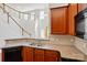 Modern kitchen features granite countertops, stainless steel appliances, and warm wood cabinets at 6333 Cory Bret Ln, Charlotte, NC 28278
