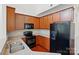 Well-equipped kitchen with dark cabinets, stainless steel appliances, and neutral countertops and hardwood floors at 6333 Cory Bret Ln, Charlotte, NC 28278