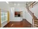 Open living room with hardwood floors, white walls, and natural light, open to kitchen, and staircase at 6333 Cory Bret Ln, Charlotte, NC 28278