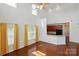 Sunlit living room with hardwood floors and large windows open to the kitchen area for easy entertaining at 6333 Cory Bret Ln, Charlotte, NC 28278