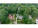 Lushly wooded neighborhood with aerial view of the home, pool, detached garage, and meticulous landscaping at 6745 Wheeler Dr, Charlotte, NC 28211