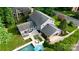 Aerial view of home with a pool, patio, detached garage, and well-maintained lawn and landscaping at 6745 Wheeler Dr, Charlotte, NC 28211