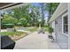 Landscaped backyard features a luxurious pool, a covered gazebo, outdoor seating, and a lush green lawn at 6745 Wheeler Dr, Charlotte, NC 28211