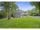 Expansive backyard featuring a pool, lush lawn, and patio area, perfect for outdoor entertaining at 6745 Wheeler Dr, Charlotte, NC 28211