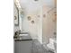 Bright bathroom featuring modern fixtures, a shower-tub, and a tiled floor at 6745 Wheeler Dr, Charlotte, NC 28211