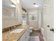 Well-lit bathroom featuring granite countertops, modern fixtures, and a bathtub at 6745 Wheeler Dr, Charlotte, NC 28211