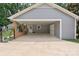 Detached carport with ample space, featuring a brick support structure and convenient side door access at 6745 Wheeler Dr, Charlotte, NC 28211