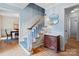 Charming foyer with hardwood floors, staircase, and tasteful decor, exuding a welcoming atmosphere at 6745 Wheeler Dr, Charlotte, NC 28211