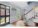 Inviting foyer with hardwood floors, a staircase, and a view to the outside, creating a warm welcome at 6745 Wheeler Dr, Charlotte, NC 28211