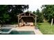 Tranquil pool side gazebo complete with outdoor seating, creating a relaxing backyard retreat at 6745 Wheeler Dr, Charlotte, NC 28211
