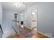 Upstairs hallway featuring hardwood floors and access to bedrooms and bathrooms at 6745 Wheeler Dr, Charlotte, NC 28211