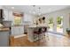 Bright kitchen with an island, pendant lights, and a view of the backyard at 6745 Wheeler Dr, Charlotte, NC 28211