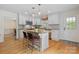 Well-lit kitchen with white cabinets, a central island, and stainless steel appliances for the home chef at 6745 Wheeler Dr, Charlotte, NC 28211