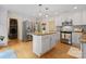 Spacious kitchen featuring a center island, stainless steel appliances, and modern lighting fixtures at 6745 Wheeler Dr, Charlotte, NC 28211