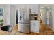 Modern kitchen featuring stainless steel refrigerator, white cabinetry, and hardwood floors at 6745 Wheeler Dr, Charlotte, NC 28211