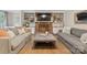 Bright living room with hardwood floors and a brick fireplace flanked by built-in shelving and cabinetry at 6745 Wheeler Dr, Charlotte, NC 28211