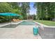 Stunning pool area featuring a spa, poolside lounge chairs, and a relaxing gazebo surrounded by greenery at 6745 Wheeler Dr, Charlotte, NC 28211