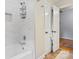 Close-up of a bathtub with a shower featuring tiled walls and modern fixtures at 6745 Wheeler Dr, Charlotte, NC 28211