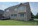 Exterior of a two story brick home featuring a deck and a well-maintained lawn at 707 Five Leaf Ln, Waxhaw, NC 28173