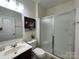 Bathroom featuring a glass shower door, toilet, and single sink vanity at 707 Five Leaf Ln, Waxhaw, NC 28173