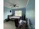 Well-lit bedroom features a ceiling fan, neutral carpet, light-blue walls and an entertainment area at 707 Five Leaf Ln, Waxhaw, NC 28173