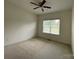 Bright bedroom with neutral carpet, ceiling fan, and window offering natural light at 707 Five Leaf Ln, Waxhaw, NC 28173
