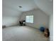 Spacious carpeted bonus room with vaulted ceiling, natural light, and office area at 707 Five Leaf Ln, Waxhaw, NC 28173