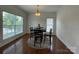 Bright breakfast nook with hardwood floors, large window, and modern table set with seating for four at 707 Five Leaf Ln, Waxhaw, NC 28173