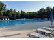 Inviting community swimming pool with lounge chairs, umbrellas, and a refreshing fountain for relaxation at 707 Five Leaf Ln, Waxhaw, NC 28173