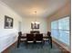 Elegant dining room featuring hardwood floors, a chandelier, and a large table with seating for six at 707 Five Leaf Ln, Waxhaw, NC 28173