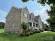 Two story brick home with green lawn and landscaping at 707 Five Leaf Ln, Waxhaw, NC 28173