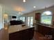 Open kitchen flows to living room with island, granite countertops, and stainless appliances at 707 Five Leaf Ln, Waxhaw, NC 28173