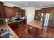 Bright kitchen features stainless appliances, granite countertops and wood cabinets at 707 Five Leaf Ln, Waxhaw, NC 28173