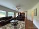 Bright living room with hardwood floors, ceiling fan, and view into the kitchen at 707 Five Leaf Ln, Waxhaw, NC 28173