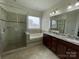 Primary bathroom featuring a glass shower, a tub, and double sinks at 707 Five Leaf Ln, Waxhaw, NC 28173