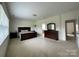 Spacious primary bedroom with neutral carpeting, natural light, and space for a dresser and nightstands at 707 Five Leaf Ln, Waxhaw, NC 28173