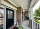 Front porch and entryway of a brick home, featuring decorative glass door and brick columns at 707 Five Leaf Ln, Waxhaw, NC 28173